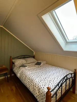 a bedroom with a bed with a skylight at Bakkebo Rampestreken in Åndalsnes