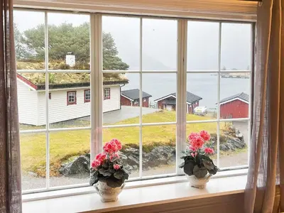 a window with two vases with flowers on a window sill at 8 person holiday home in Flatraket-By Traum in Barmen