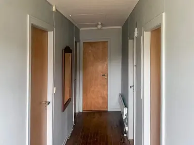 a hallway with a wooden door in a room at 8 person holiday home in Flatraket-By Traum in Barmen