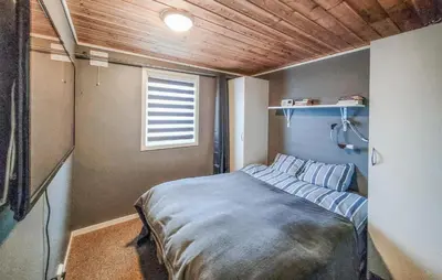 a small bedroom with a bed with blue sheets at Nice Home In Jelsa With Kitchen in Jelsa