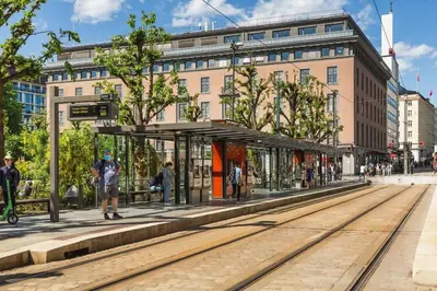 a man standing at a train station in a city at Dinbnb Apartments I Family Dream in Bergen I Playroom I Private Garden in Bergen