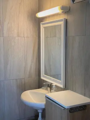 a bathroom with a sink and a mirror at Hole Hytter in Geiranger