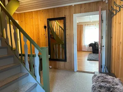 a hallway with a staircase leading to a living room at Stort hus sentralt i Lillehammer in Lillehammer