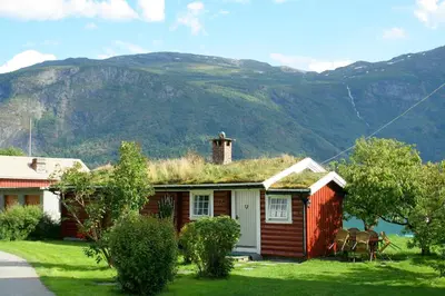 a small house with a grass roof on top of it at Dalsøren Camping og hytter in Luster