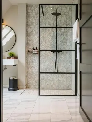 a bathroom with a shower with a glass door at Vertshuset Konow in Bergen