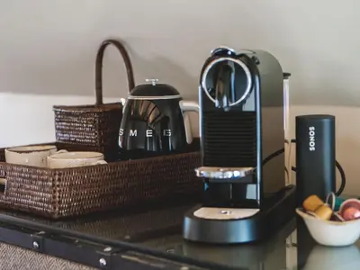 a coffee maker and a basket on a table at Vertshuset Konow in Bergen