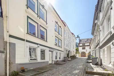an empty street in an alley with buildings at Renovated 2024 - Viking inspired - Behind bryggen in Bergen