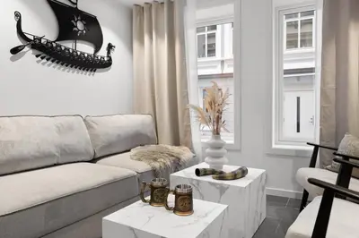 a living room with a couch and a table at Renovated 2024 - Viking inspired - Behind bryggen in Bergen