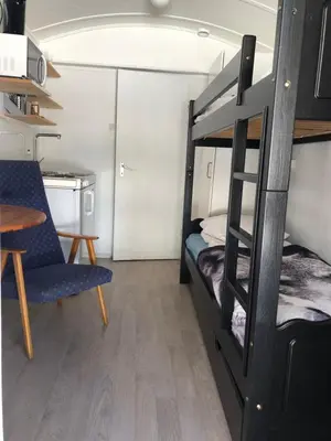 a small room with a bunk bed and a table at Rena Hostel in Rena