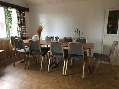 a dining room with a wooden table and chairs at Rena Hostel in Rena