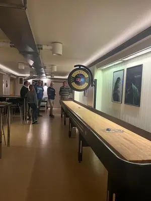 a group of people walking down a hallway with a clock at Rena Hostel JOHANNES in Rena