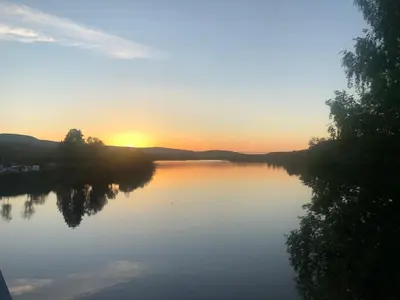 a view of a river with the sun setting at Rena Hostel JOHANNES in Rena