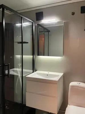 a bathroom with a white sink and a shower at Spacious villa with view - 5BR - FREE parking - Great Wi-Fi in Bergen