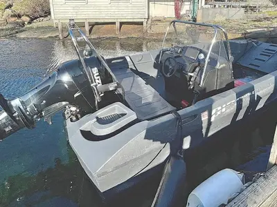 a small boat tied to a dock in the water at 6 person holiday home in Dalsøyra-By Traum in Dalsøyra