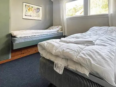 a bedroom with two beds and a window at 6 person holiday home in Dalsøyra-By Traum in Dalsøyra