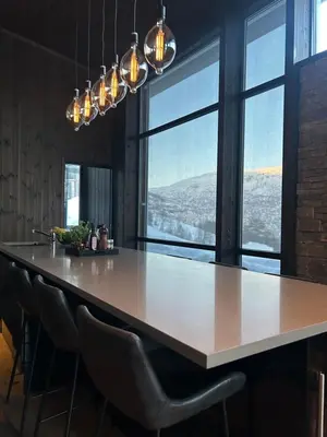 a large kitchen with a large table and chairs at Pow Panorama - High standard Mountain home in Sogndal