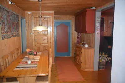 a kitchen with a wooden table and a blue door at Einkjerrbu cabin by Norgesbooking - in Svingvoll