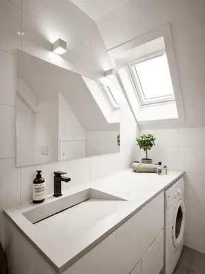 a white bathroom with a sink and a skylight at Modern Penthouse in Sandviken in Bergen
