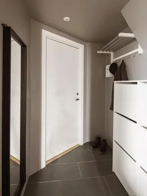 a large white door in a room with a tile floor at Modern Penthouse in Sandviken in Bergen