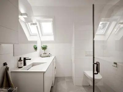 a white bathroom with a sink and a toilet at Modern Penthouse in Sandviken in Bergen