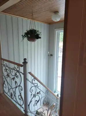 a room with a staircase with a plant on the ceiling at Sveciu namai in Sandeid