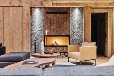 a living room with a fireplace and a couch at Chalet Strandafjellet in Stranda