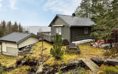 a small house on a hill next to a house at 4 Bedroom Beautiful Home In Sekken in Molde