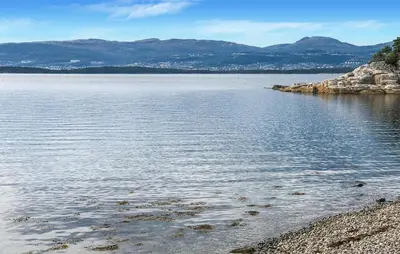 a large body of water with mountains in the background at 4 Bedroom Beautiful Home In Sekken in Molde