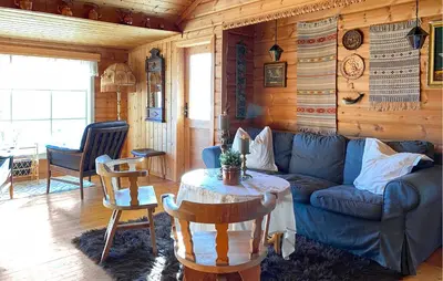 a living room with a blue couch and a table at 2 Bedroom Cozy Home In Skodje in Skodje