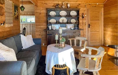 a living room with a couch and a table in a cabin at 2 Bedroom Cozy Home In Skodje in Skodje