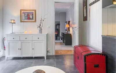 a living room with a red bench and a hallway at Nice Apartment In Bjorli With Wifi in Bjorli