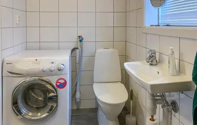 a bathroom with a washing machine and a sink at Nice Apartment In Bjorli With Wifi in Bjorli