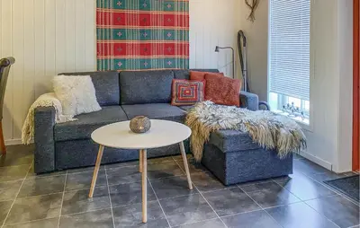 a living room with a couch and a table at Nice Apartment In Bjorli With Wifi in Bjorli