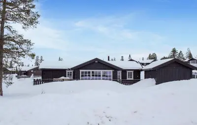 a house in the snow with snow covered grounds at 4 Bedroom Nice Home In Engerdal in Kvisla