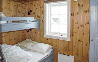 a bedroom with a bunk bed and a window at 4 Bedroom Nice Home In Engerdal in Kvisla