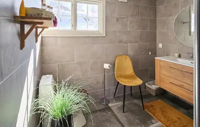 a bathroom with a chair and plants in it at Gorgeous Home In Rjukan With Kitchen in Rjukan