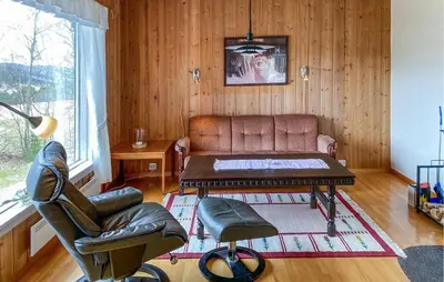 a living room with a couch and a table at Stunning Apartment In Eidsvåg I Romsdal in Toven