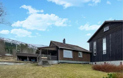 a large black house with a grass yard at Stunning Apartment In Eidsvåg I Romsdal in Toven