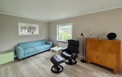 a living room with a blue couch and a chair at Amazing Home In Vikebygd With Wifi in Vikebygd
