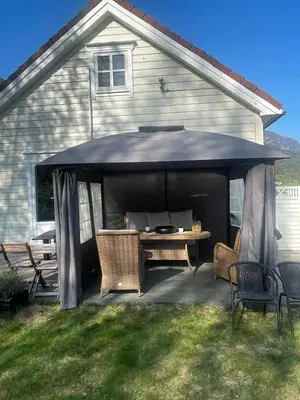 a large black gazebo with a table and chairs at Stryn Golden Resort-«Skulehuset» in Stryn