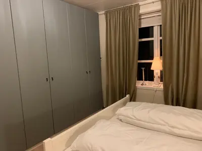 a bedroom with a white bed and a window at Stryn Golden Resort-«Skulehuset» in Stryn