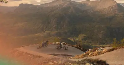 two people riding bikes on a mountain road at Ski in/out Appartment Hemsedal in Hemsedal