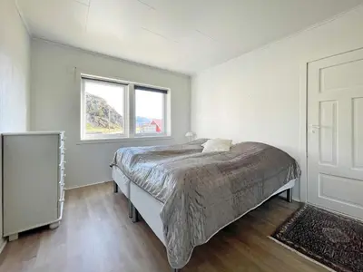 a bedroom with a bed and a window at 8 person holiday home in Bremanger in Grotle