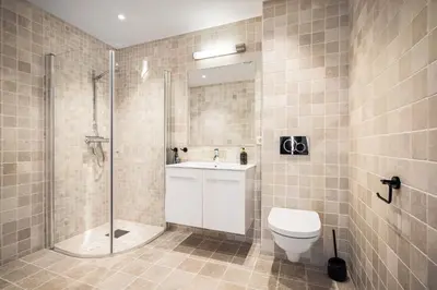 a bathroom with a shower and a toilet and a sink at Gullstein in Geilo
