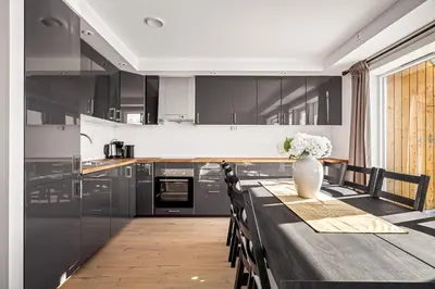 a kitchen with a table with a vase of flowers on it at Gullstein in Geilo