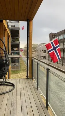 a british flag on the balcony of a building at Strøken leilighet inkl parkeringskjeller. in Trondheim