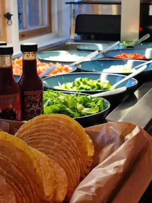 a buffet of food with bread and salad and two drinks at Oppdalsporten Motell in Oppdal