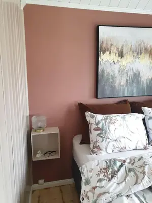 a bedroom with a bed and a painting on the wall at Romslig og særegent hus in Skodje