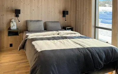 a bedroom with a large bed with a window at Pet Friendly Home In Gålå With Kitchen in Gålå