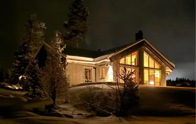 a house lit up at night in the snow at Pet Friendly Home In Gålå With Kitchen in Gålå